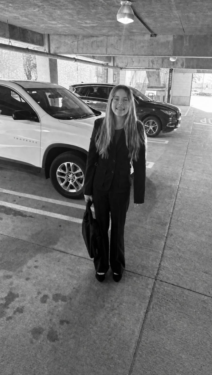 The founder, suited up with garment bag in hand, on her way to pitch the business